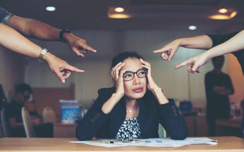 Frustrated business woman sitting at the table in office.