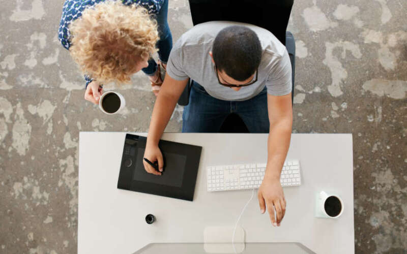 Two young people doing graphic design work